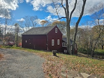 The circular driveway and the barn by the property