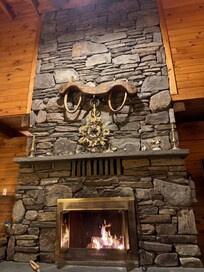 Beautiful fireplace that opens to the living room on one side and the first floor bedroom on the other!