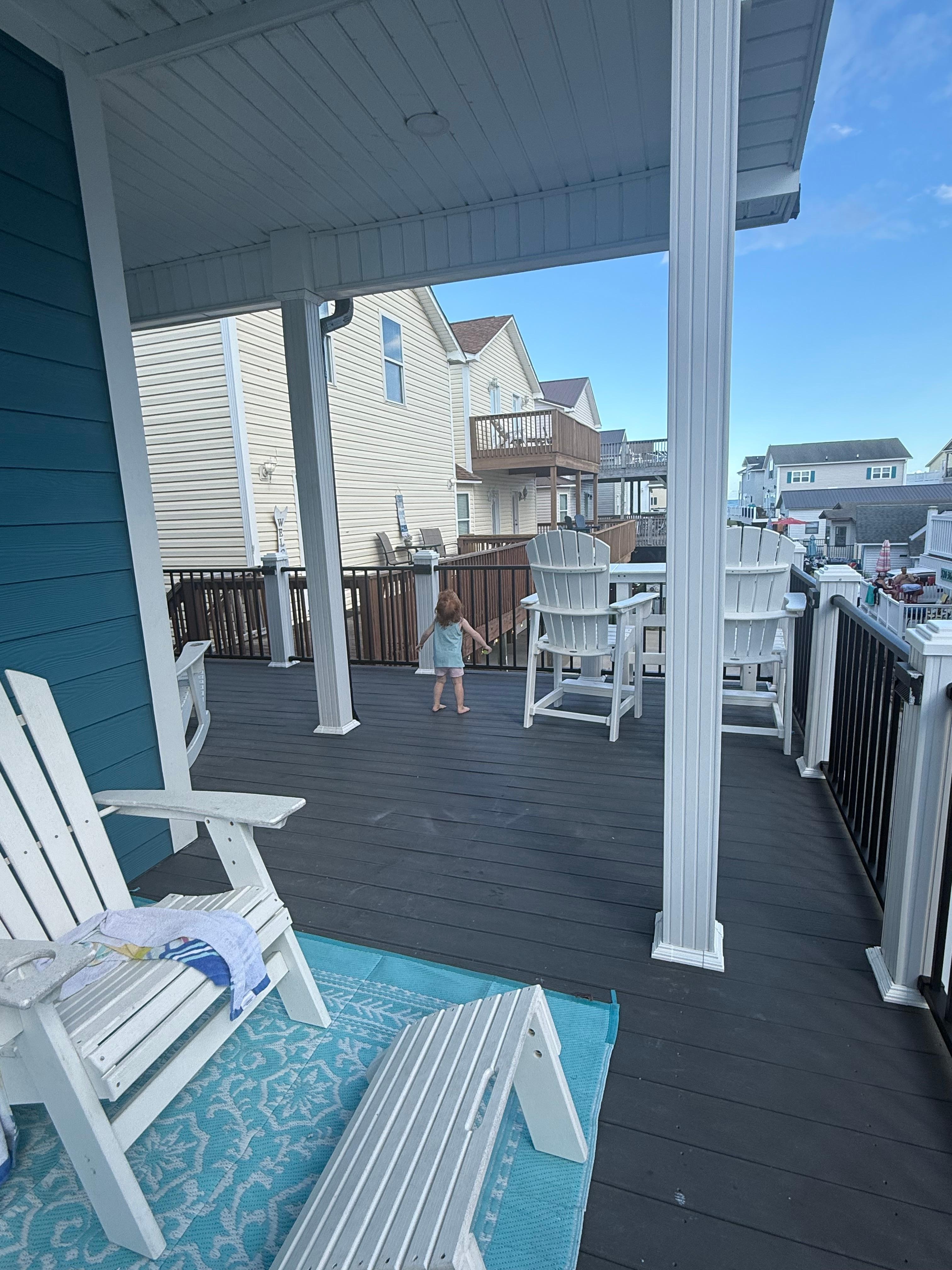 Large wrap around deck with multiple Adirondack chairs, small breakfast bar for 2, and table for 6 around the corner! Perfect for large families!