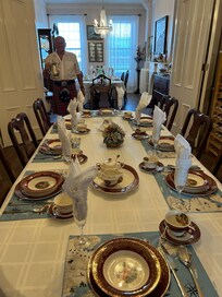 One of two formal dining tables set for breakfast with Sandy in his Royal Stewart kilt.