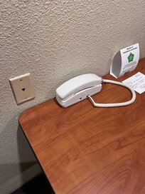Phone, but no chords attaching it to the wall.