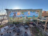 View of the side deck over looking a restaurant.