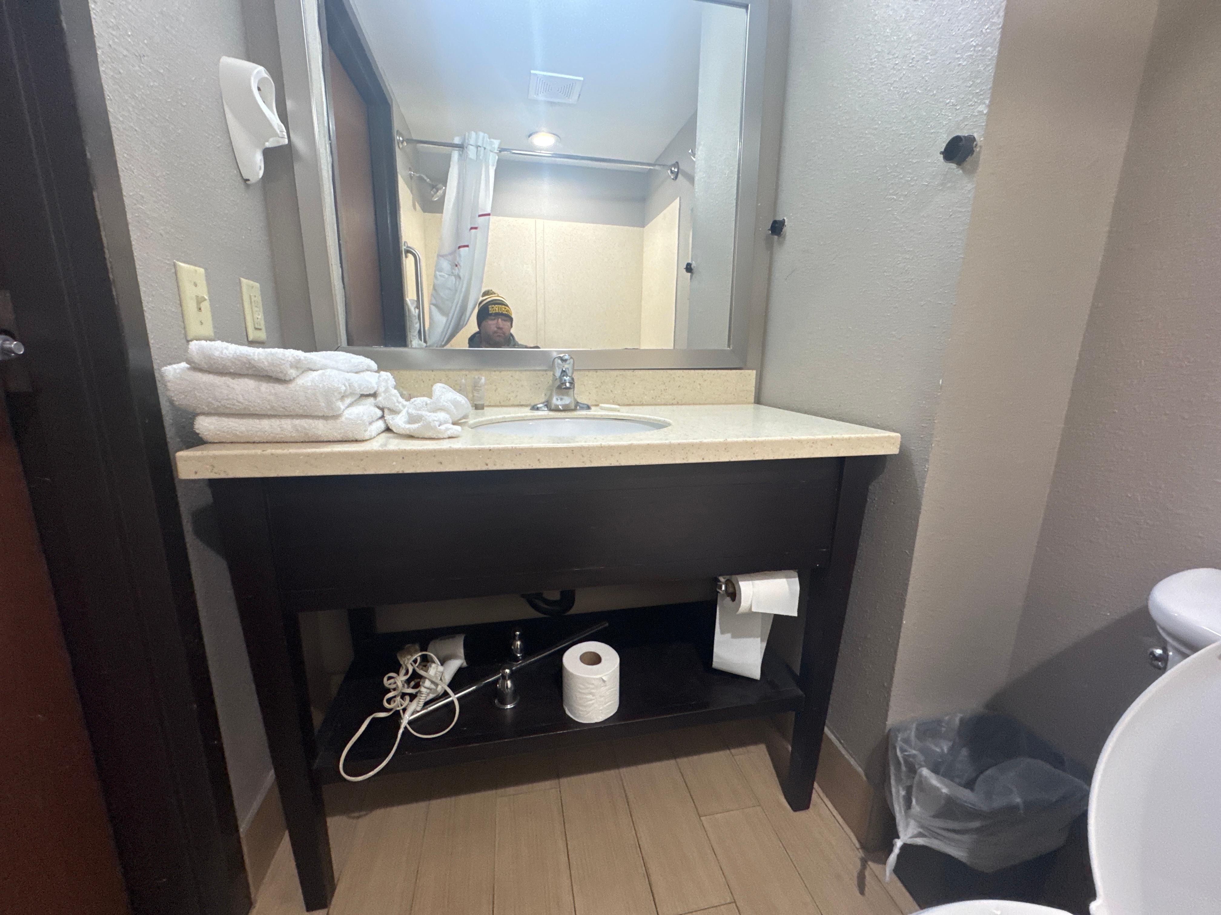 Towel rack and hair dryer just waiting to be put back on the wall I guess 