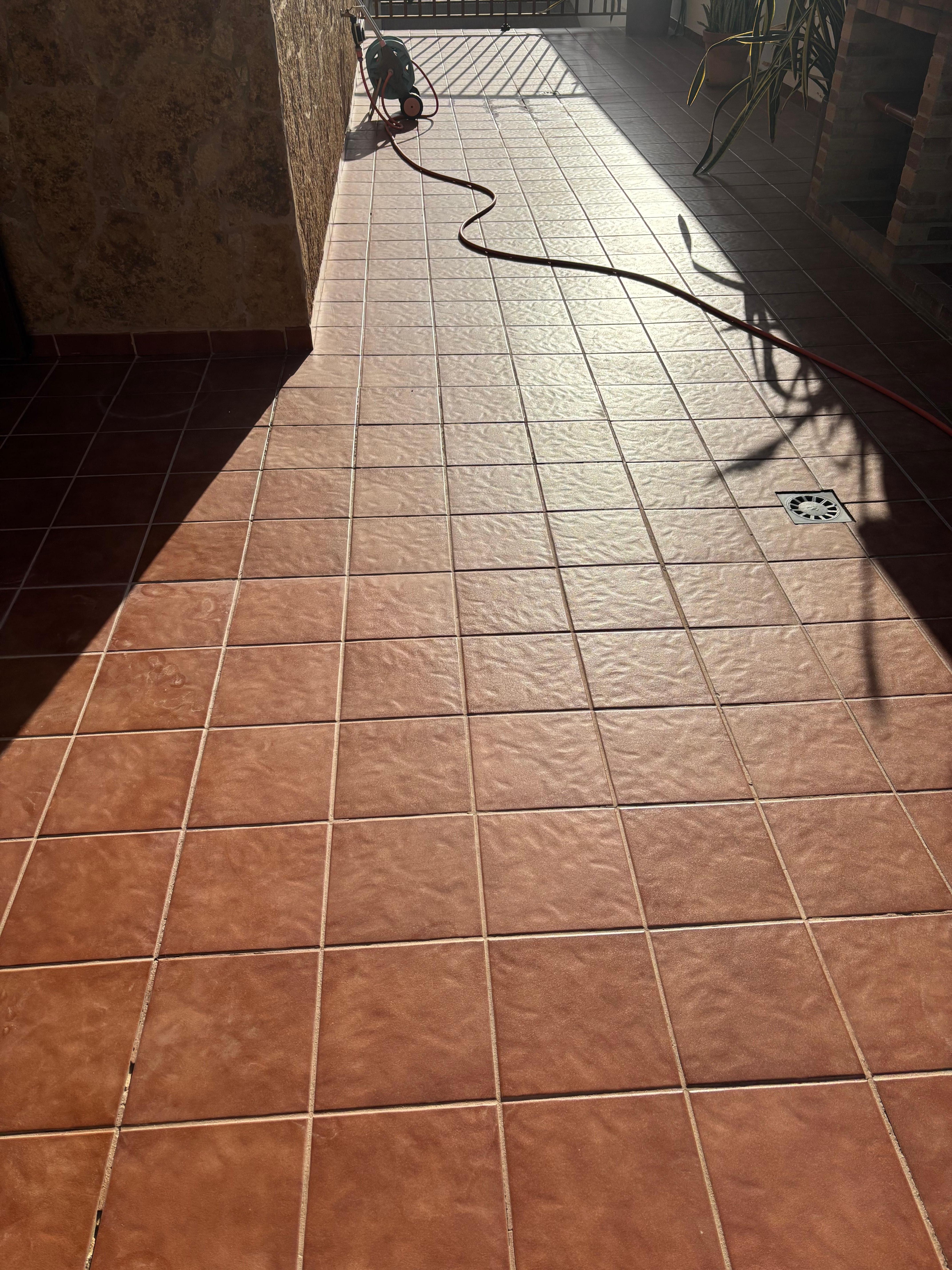 Hose pipe trailed the length of the outdoor area in front of the outdoor kitchen 