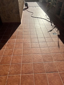 Hose pipe trailed the length of the outdoor area in front of the outdoor kitchen