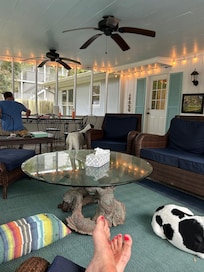 Jigsaw puzzling at screened room table with ceiling fans cooling