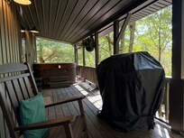 Front porch with hot tub and grill.
