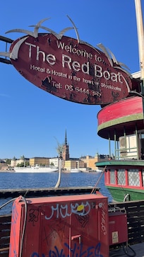 Sign for the boat and the kind of view you can glimpse if you have a room on the side of the boat away from shore.