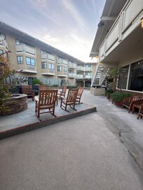 Outdoor rocking chair area with a fire pit. Tons of outdoor seating space
