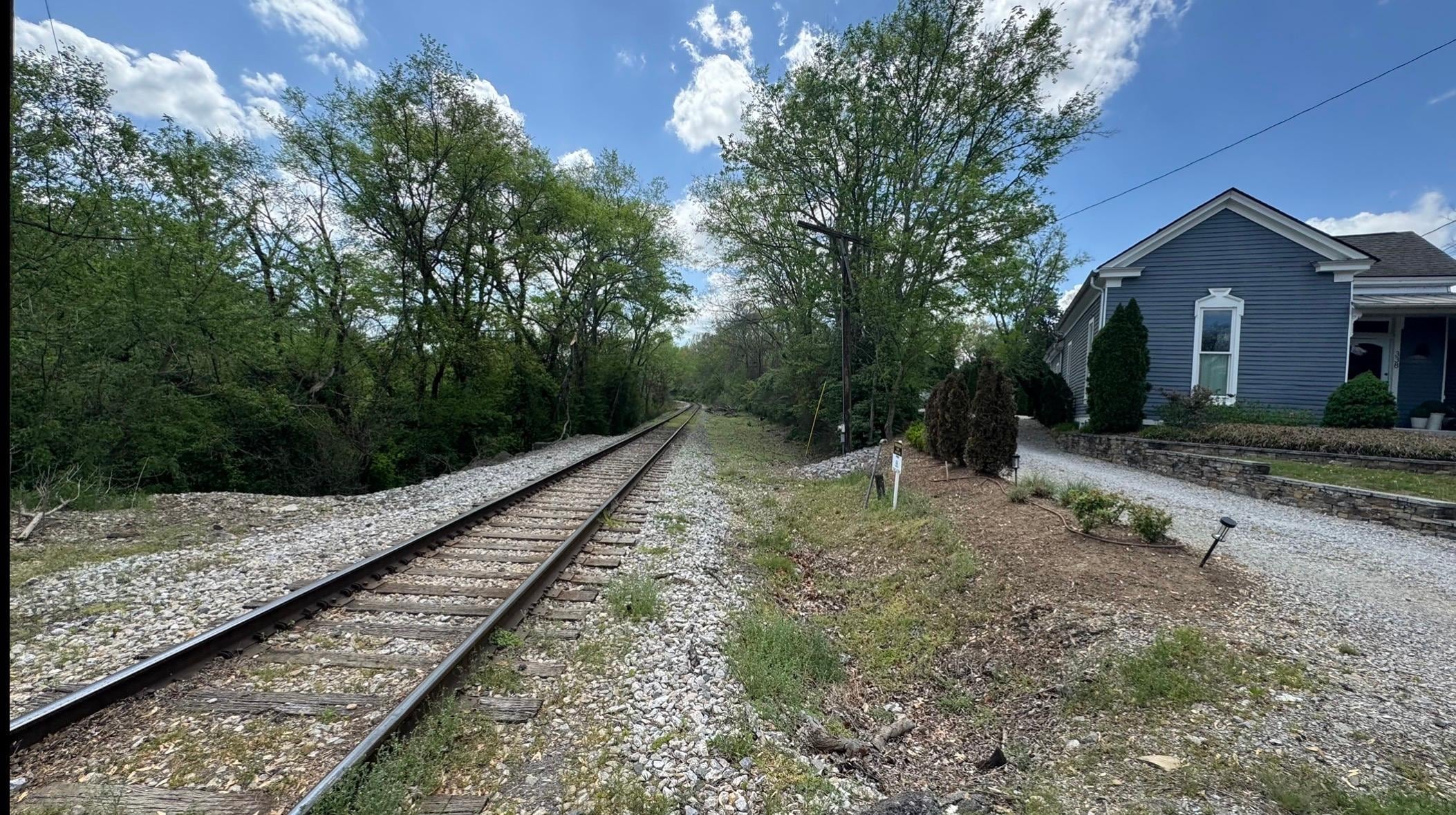 Driveway to Sugar Shack is past train tracks and behind house shown. 