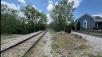 Driveway to Sugar Shack is past train tracks and behind house shown.