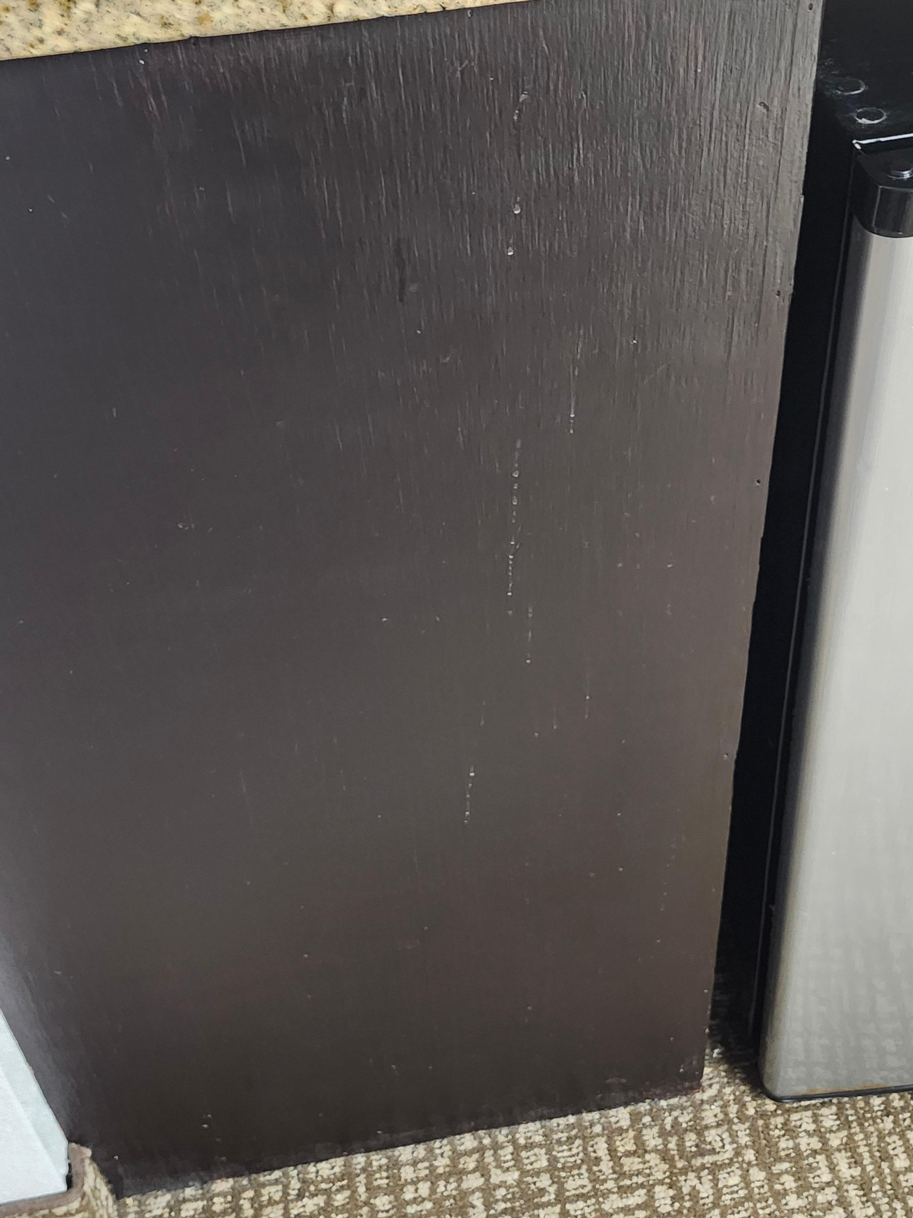 Something all over the cabinet looked like maybe a drink 