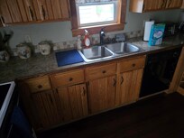 Part of large counter space in good size kitchen, range is to left.