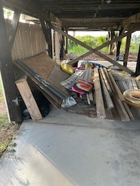Under the house in a carport.