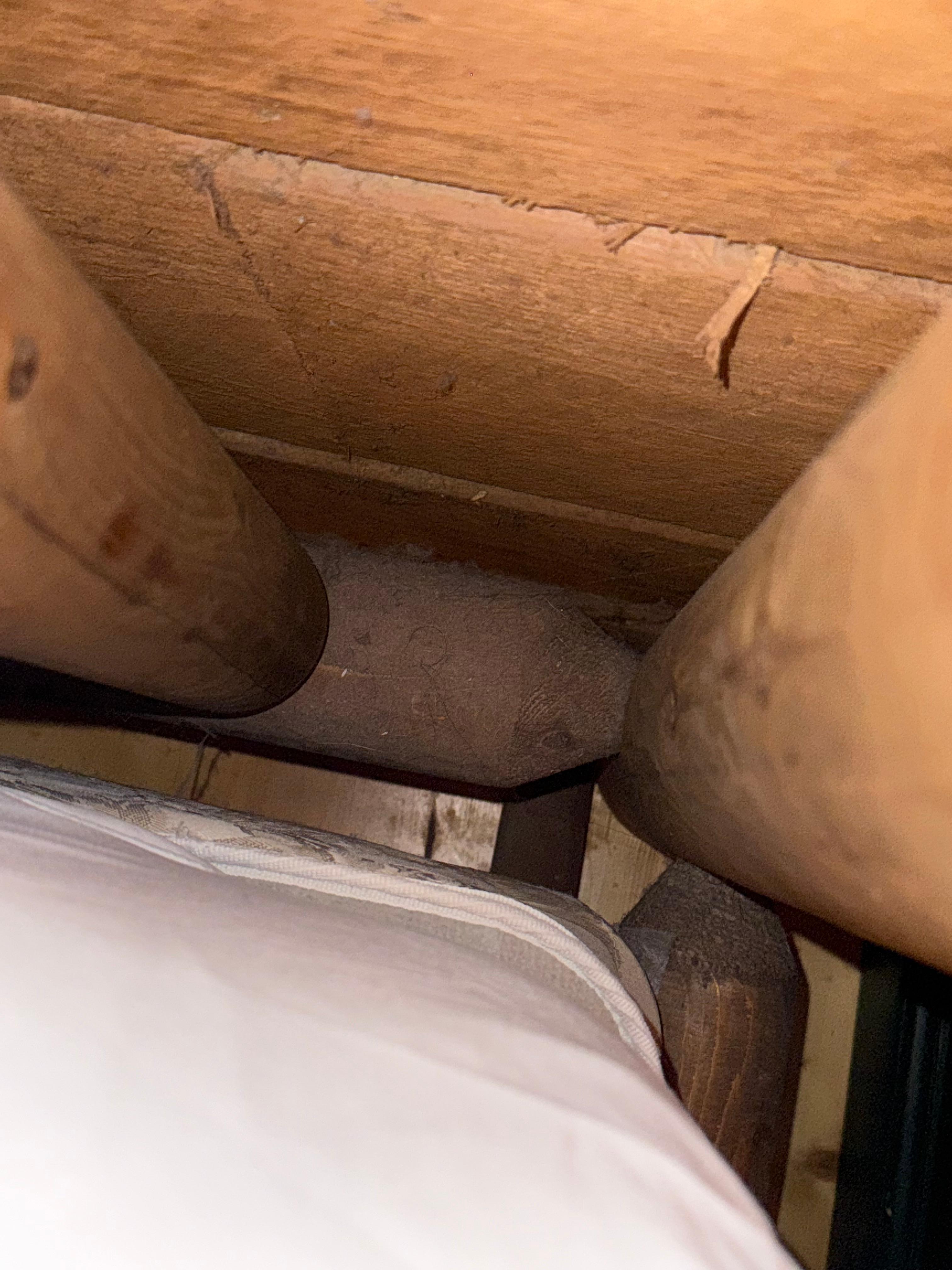 Behind bed and nightstand