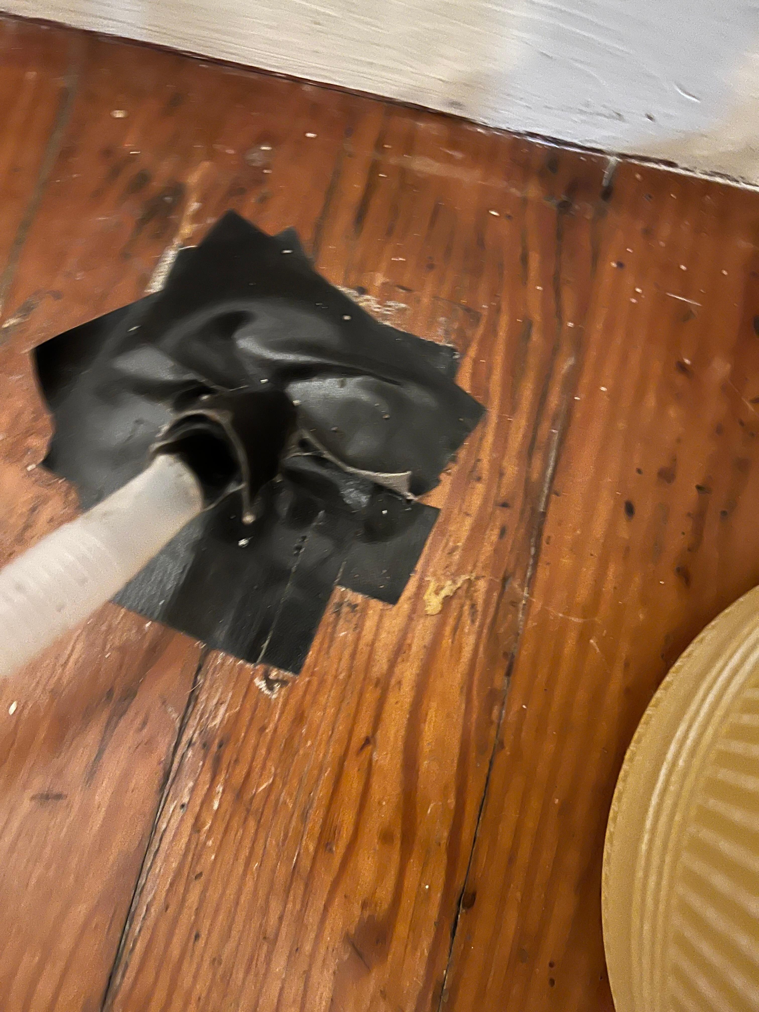 Electrical tape on floor; there is some in the bedroom and living room, covering holes. 