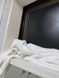 towels sealing from the cold from washroom window