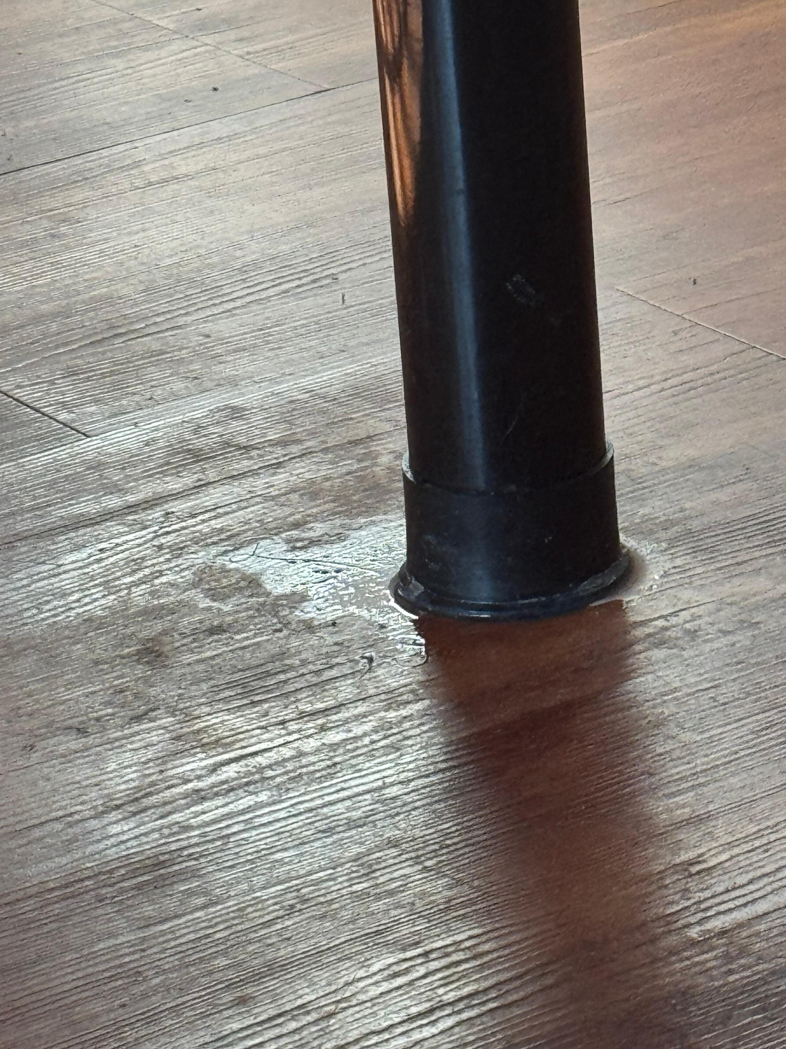 Some sort of dried up sticky substance near the bed’s foot.