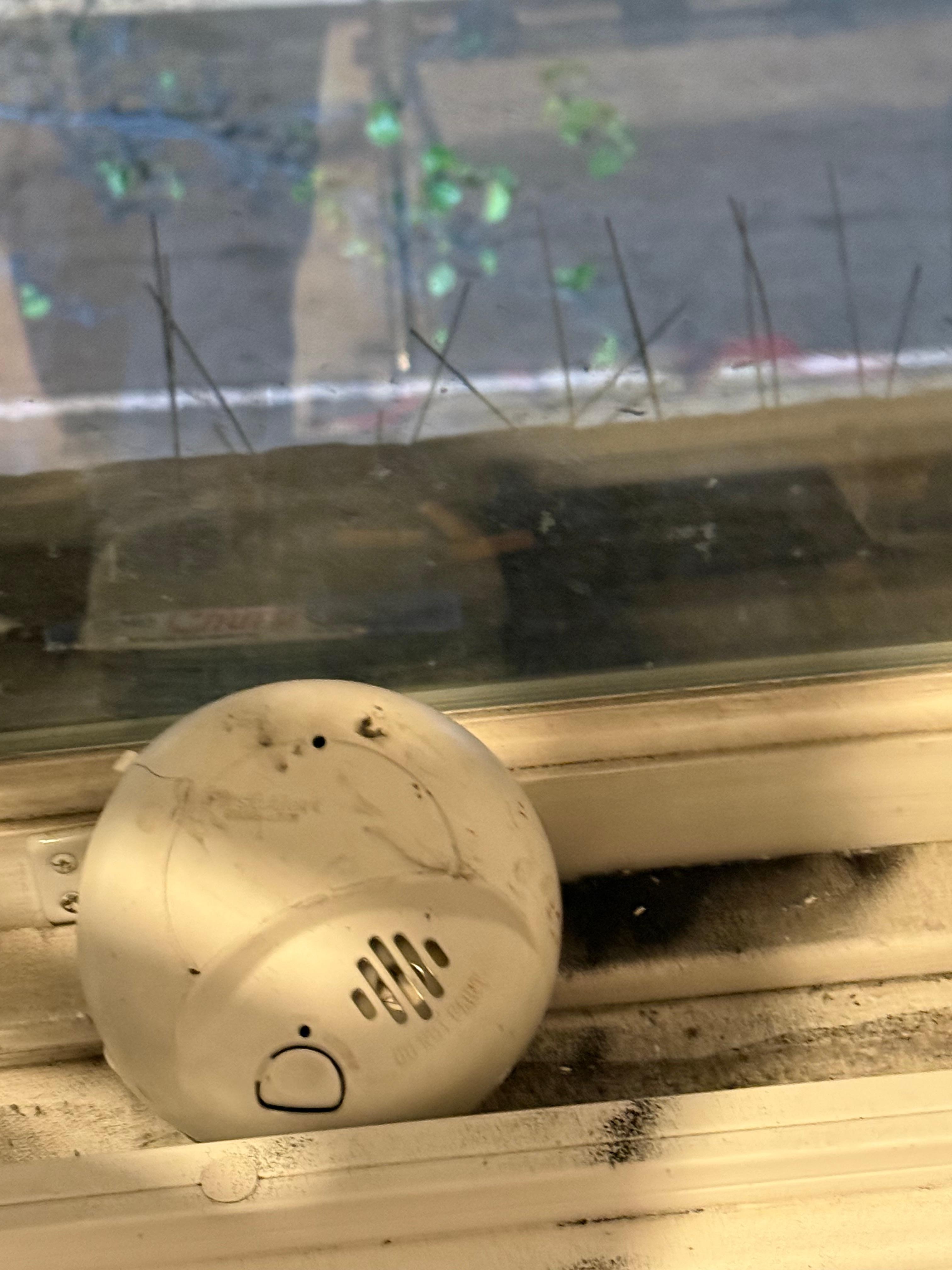 Smoke detector removed from wall and used to prop up the window….