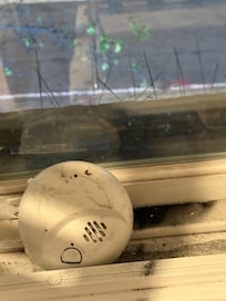 Smoke detector removed from wall and used to prop up the window….