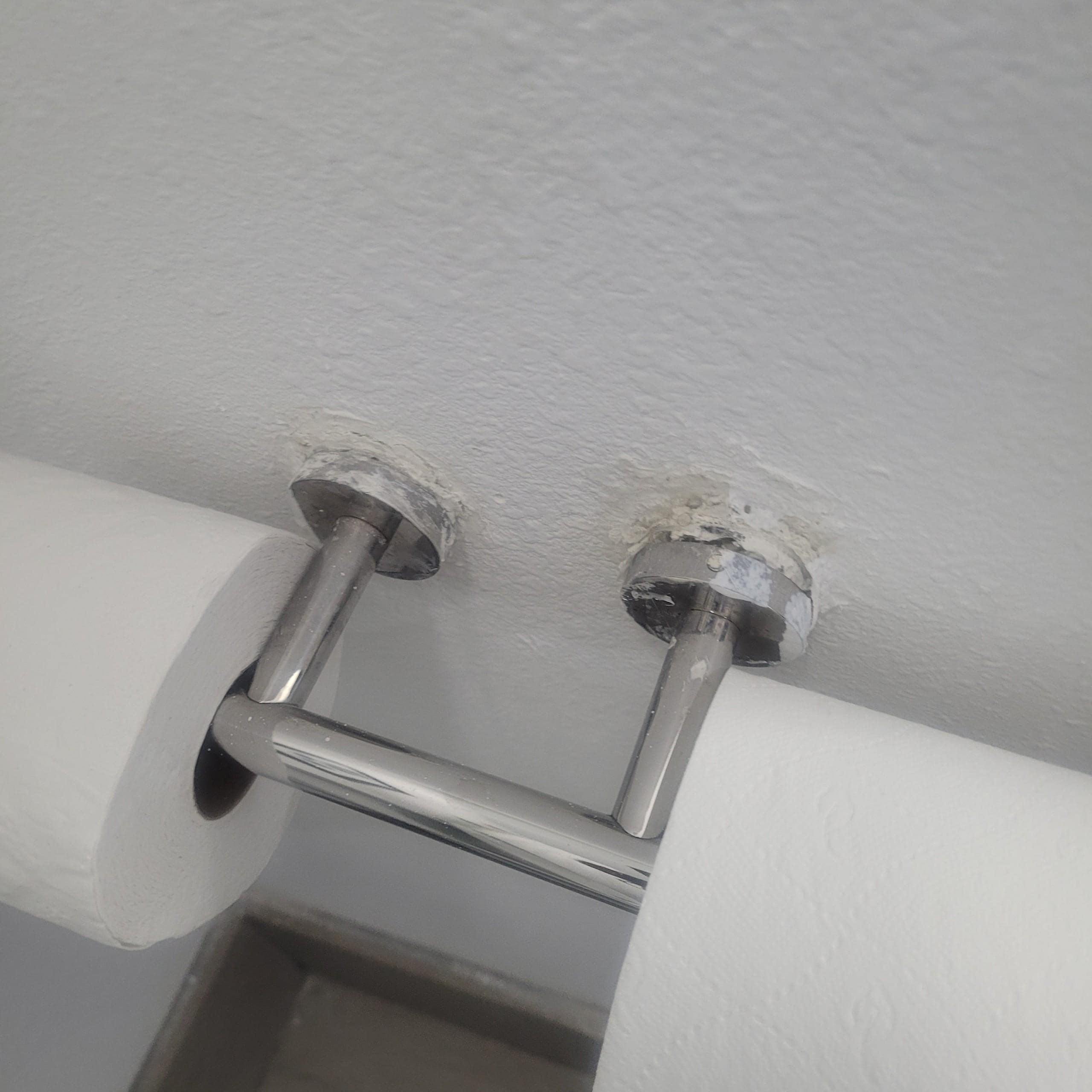 The tissue holder was coming off the wall.