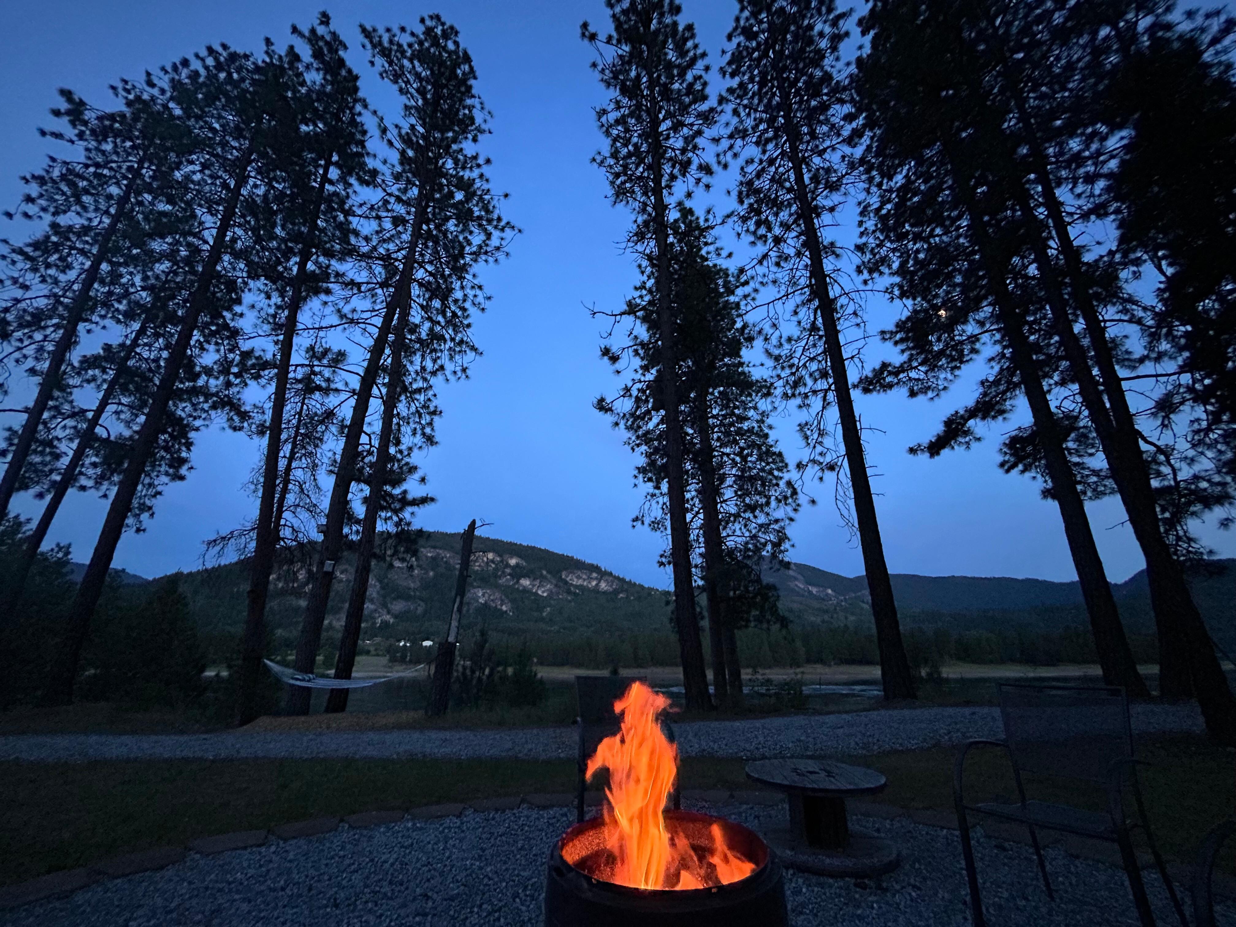 Cowboy ghost ad the lovely campfire clearing among the pines 