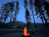 Cowboy ghost ad the lovely campfire clearing among the pines