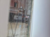 Blurry but 3 homeless men on steps near entrance