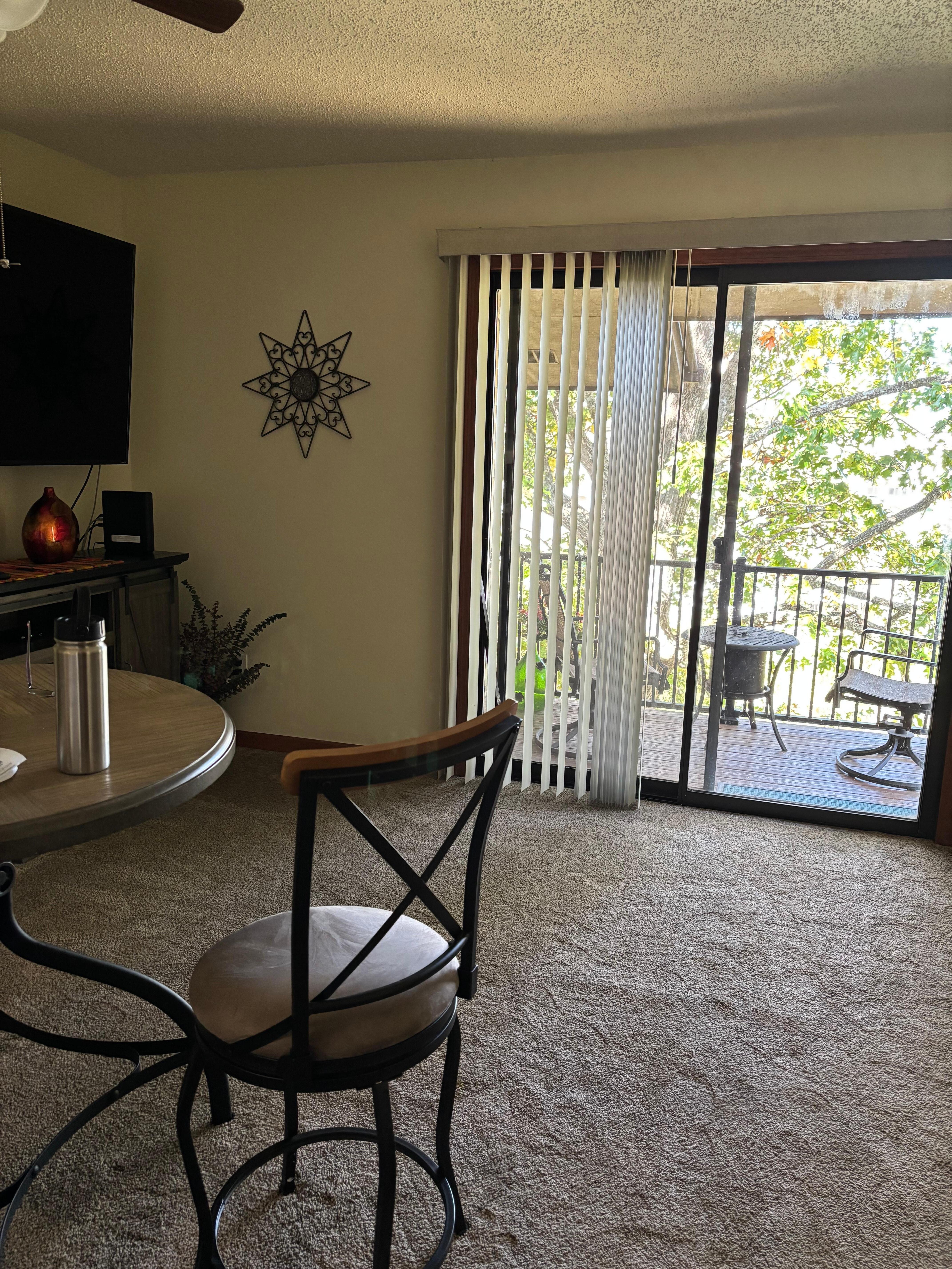 Living area with small table for two. Small balcony.
