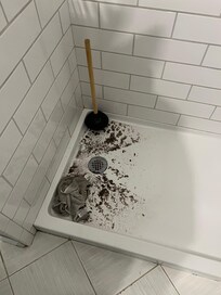 Toilet backed up into the shower this is how it was left after it was fixed