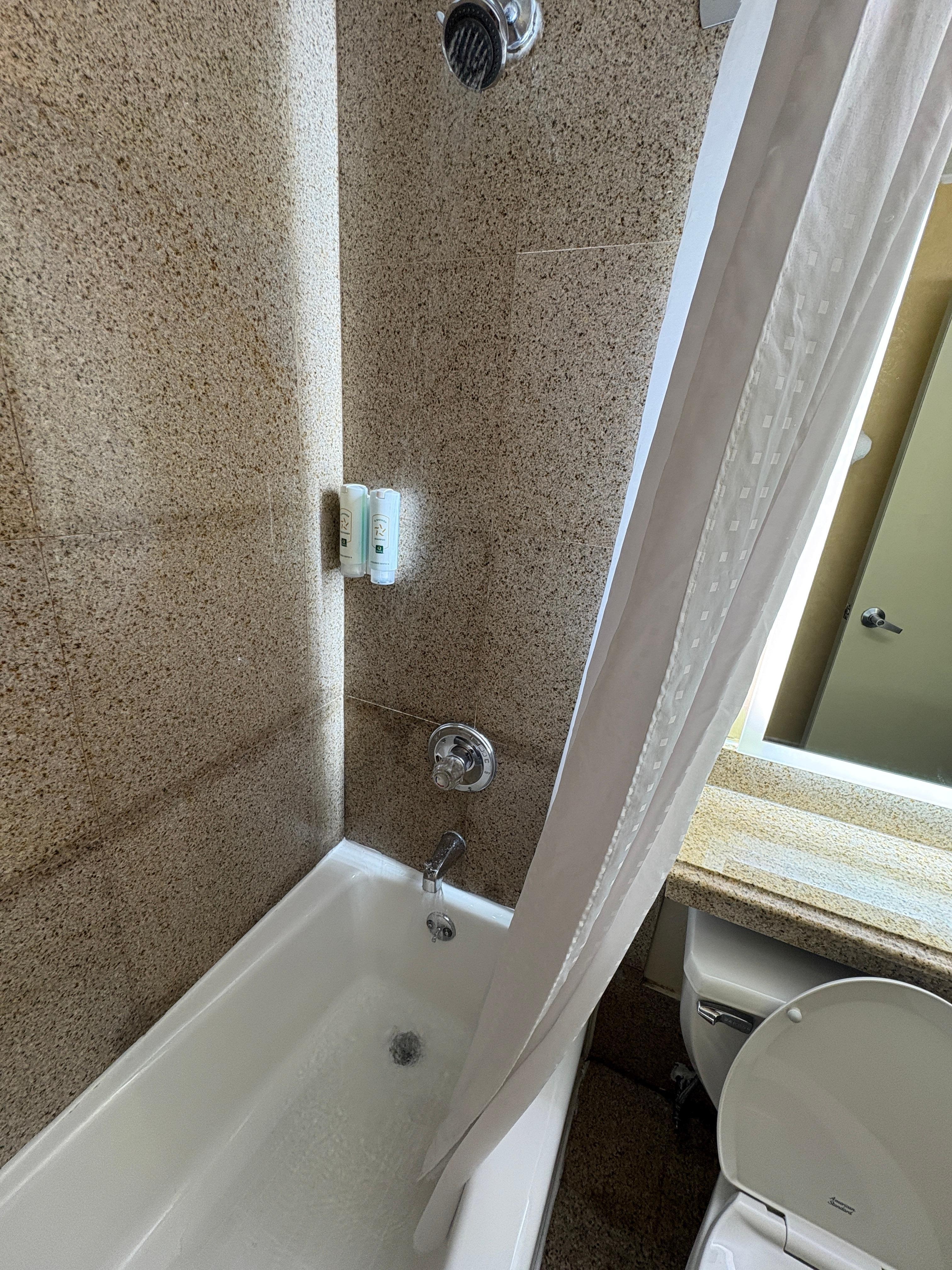 Water simultaneously coming out of both shower head and tub faucet, despite pulling lever for shower only; tub does not drain properly.