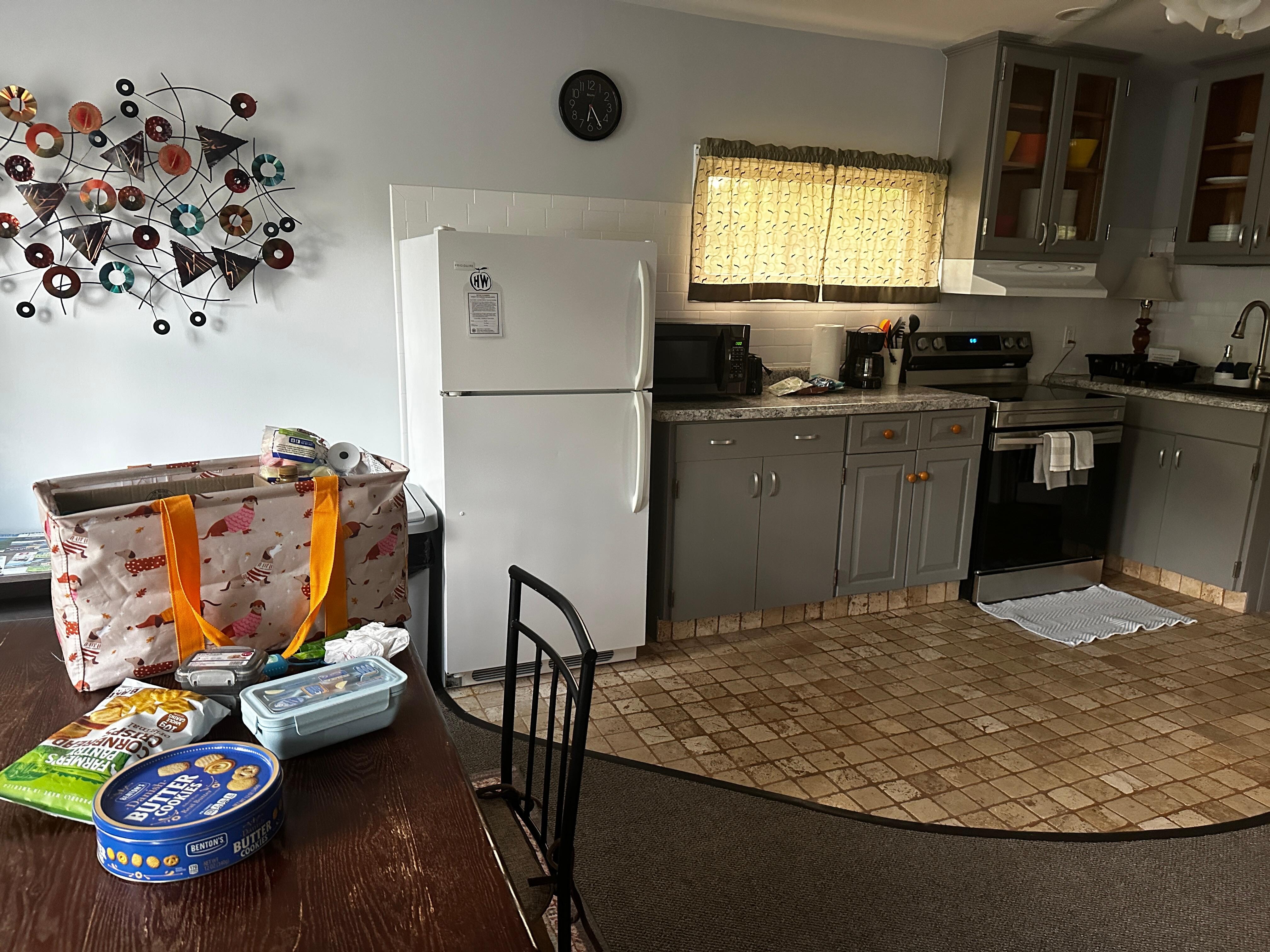 Cozy kitchen and dining table that seats 4 (my work desk for the stay!)