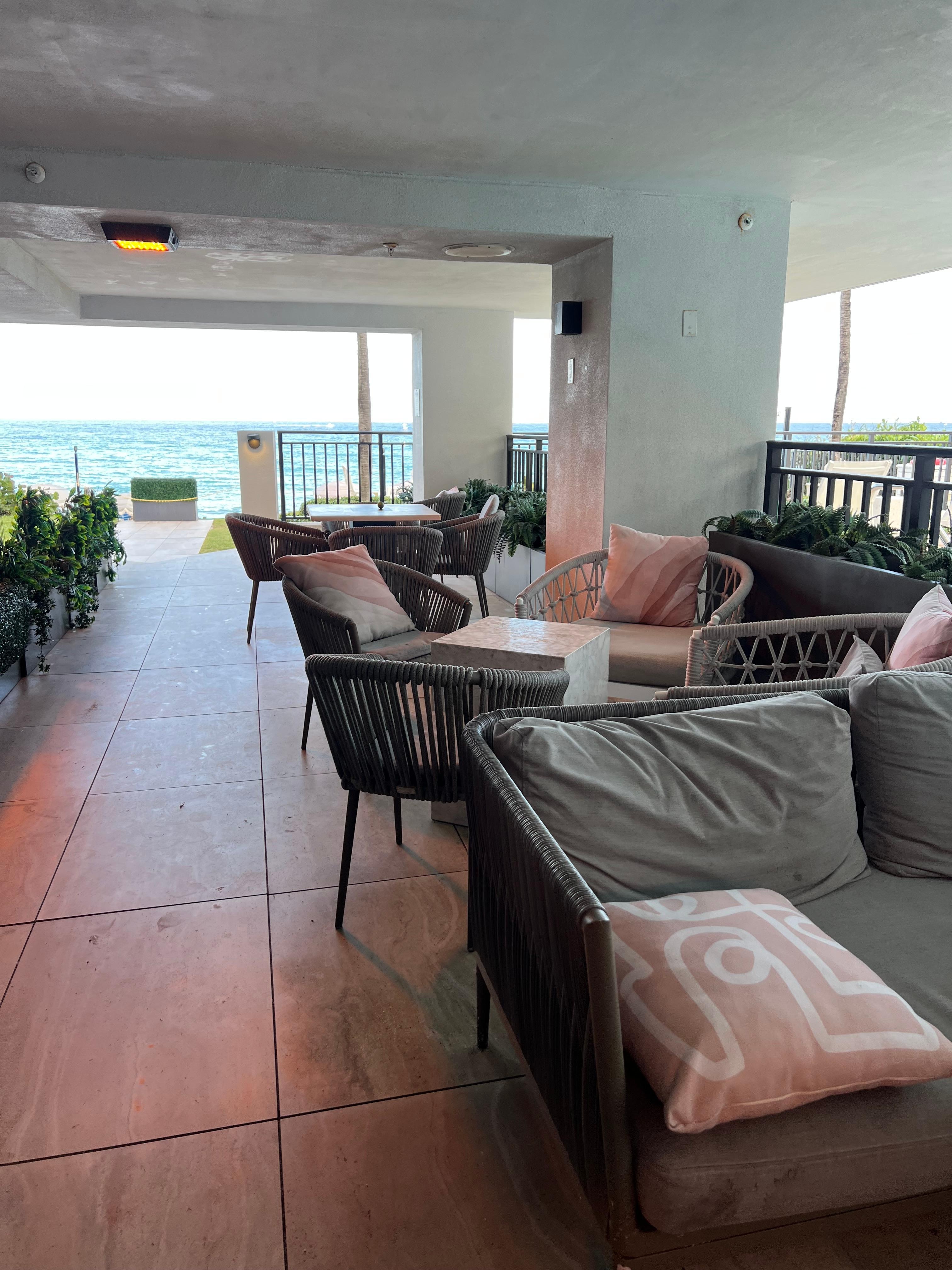 Covered deck area near pool and beach.. Sat there when a quick rain passed through..