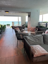 Covered deck area near pool and beach.. Sat there when a quick rain passed through..