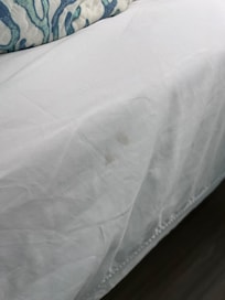 Dirty fingerprints on the side of the sheets.