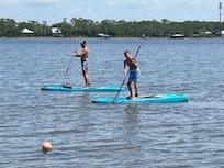 Chase and Luke paddleboarding in the Lagoon.