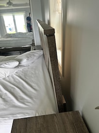 Low end furniture; headboard leans over bed.