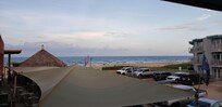 From balcony/walkway at room. Beach bar and grill on the left.