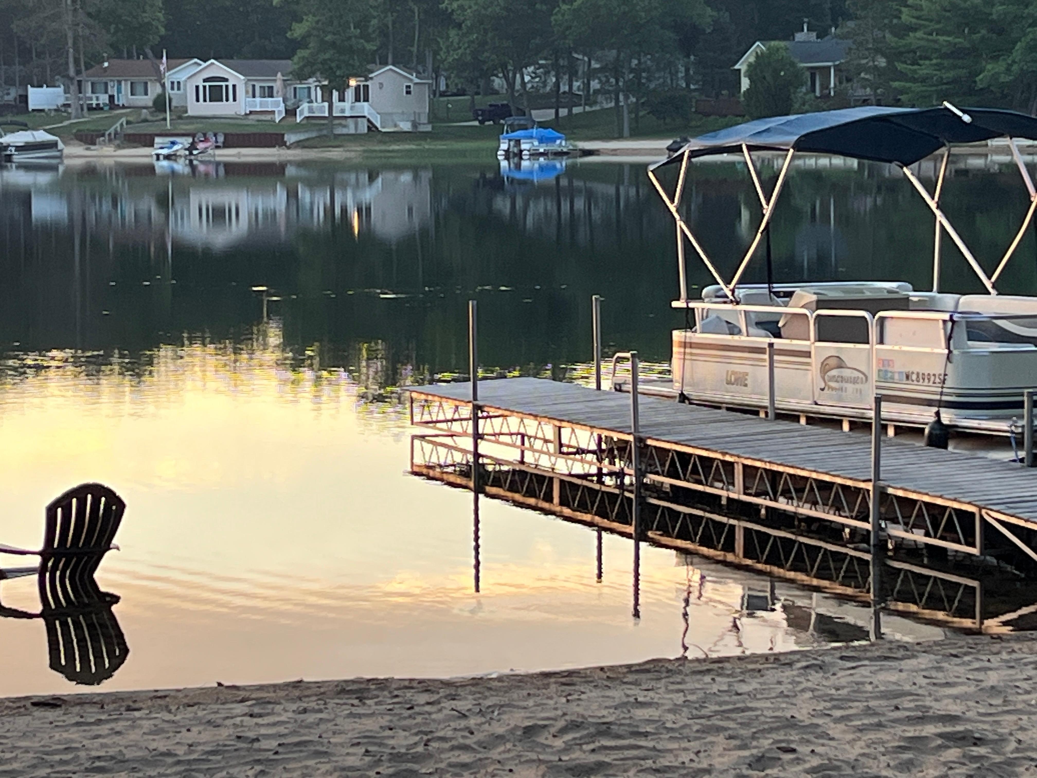 Pontoon boat on a glassy, beautiful lake