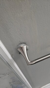 Broken towel rack in upstairs bathroom.