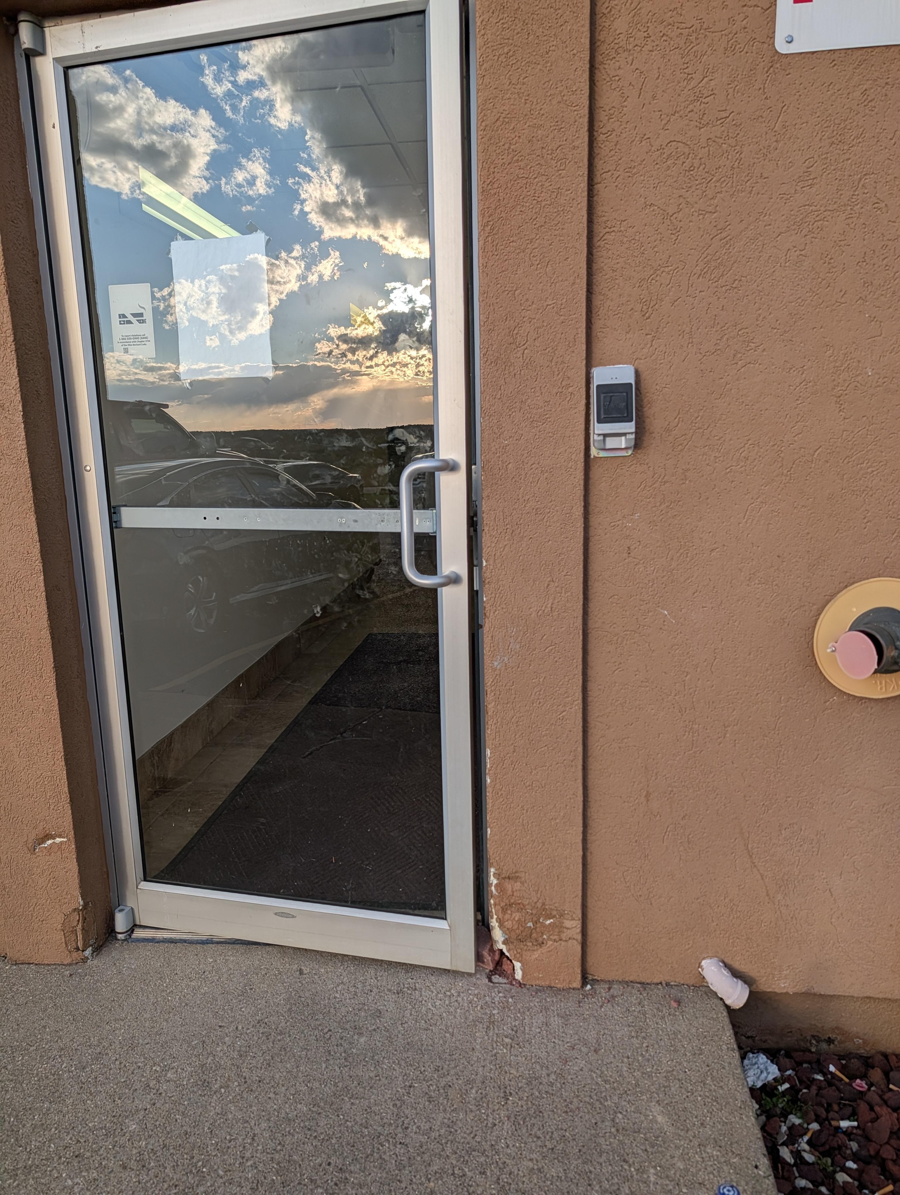 Exterior door lock broken...door held open with a rock.