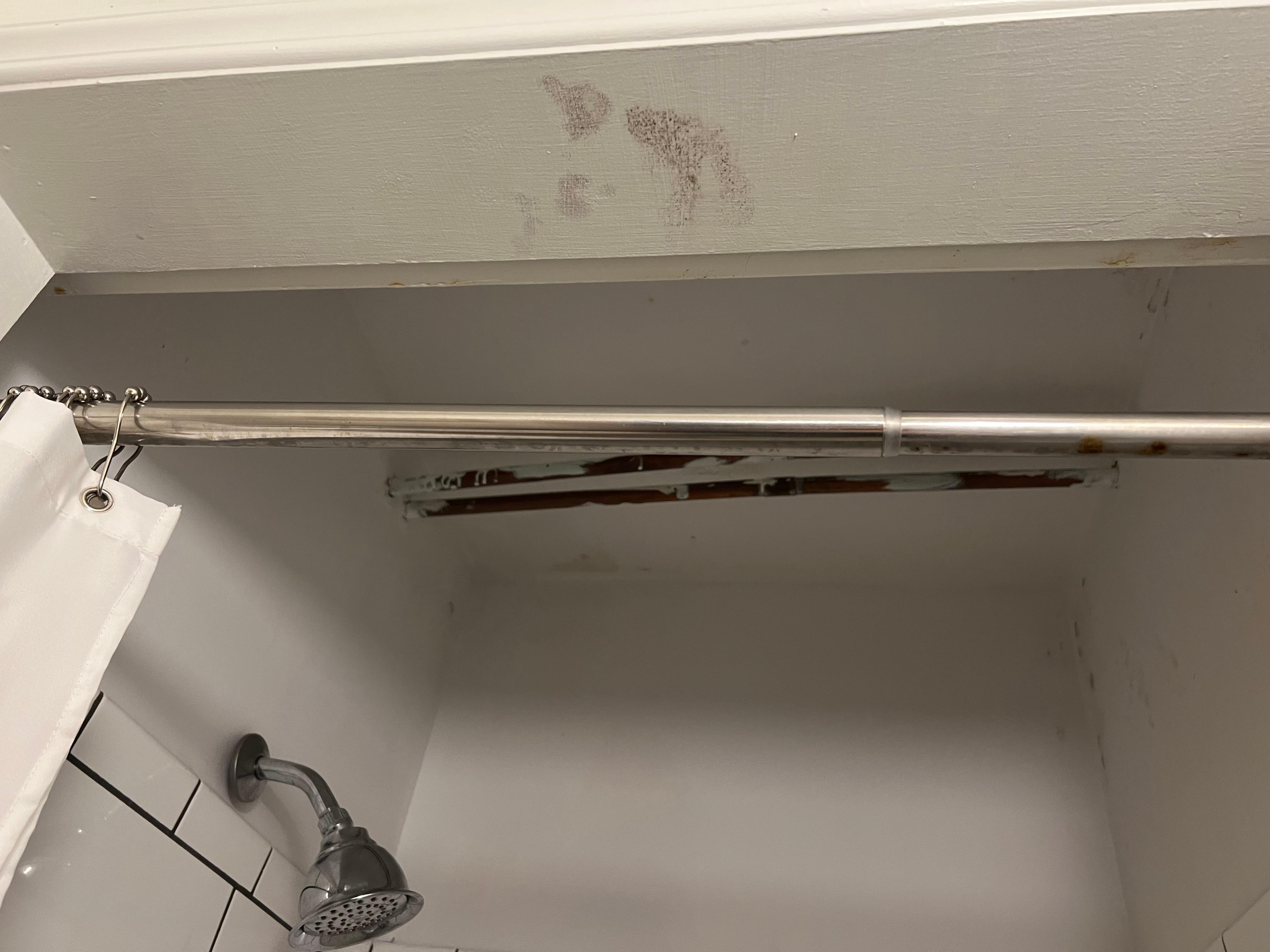 Ceiling of shower with what appears to be mold