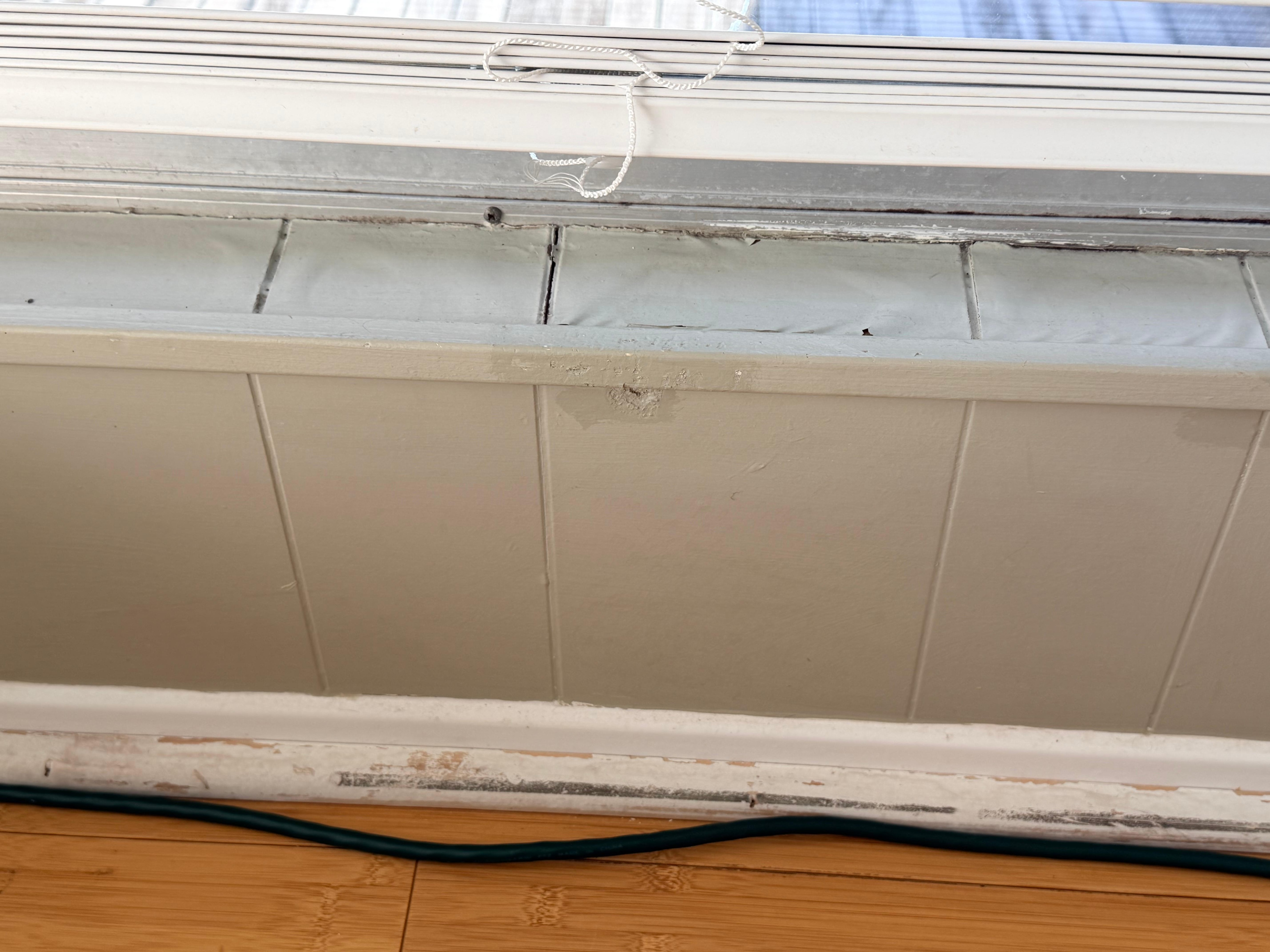 One of several peeling windowsills from prior water damage