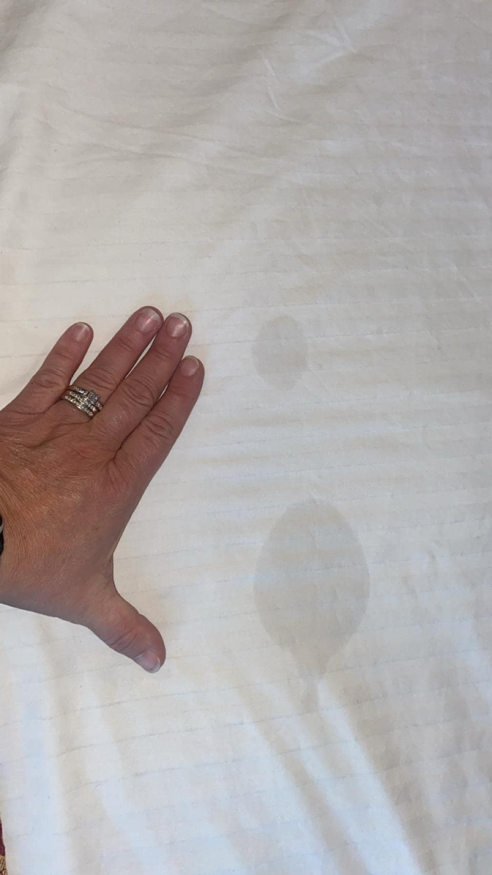 Two stains on the top of the bedding