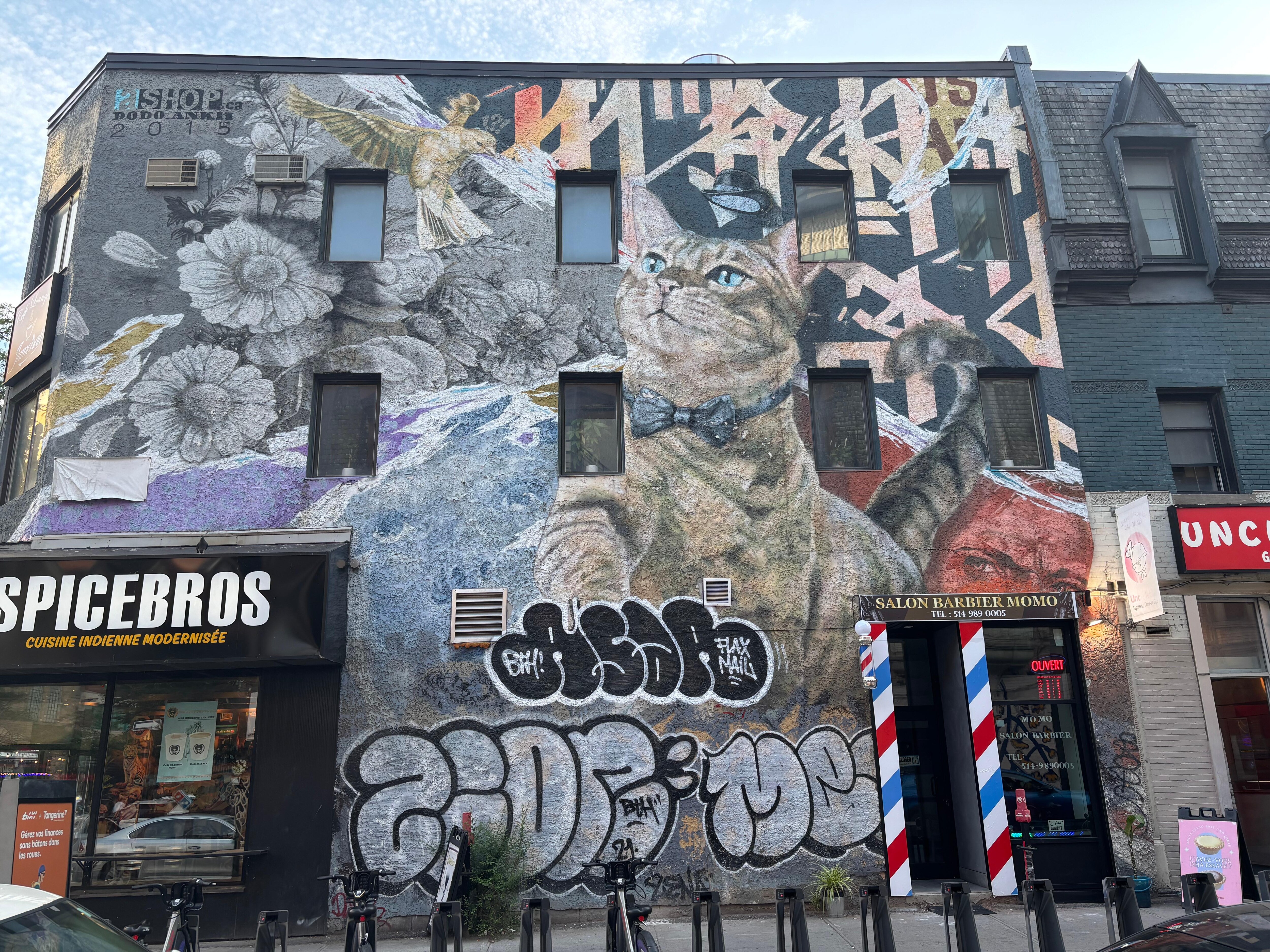 Walking downtown,saw this work of art on a wall-yes,on a wall. It was done a disservice by those  who “tagged” over it. The real “art” managed to survive,in spite of it all. It always does.