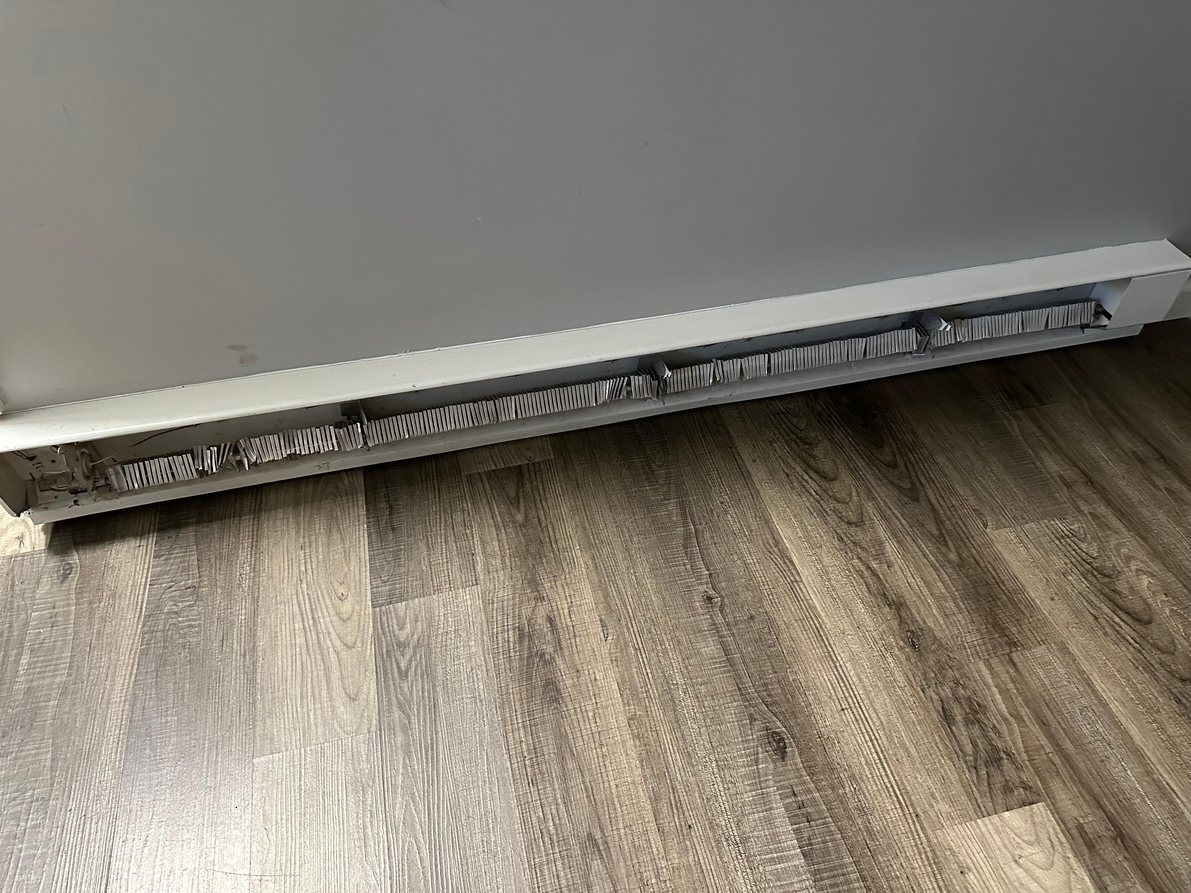 Baseboard heater panel, should have a cover.  This unsafe if little children.