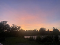Sunset over the pond at back of property from the firepit