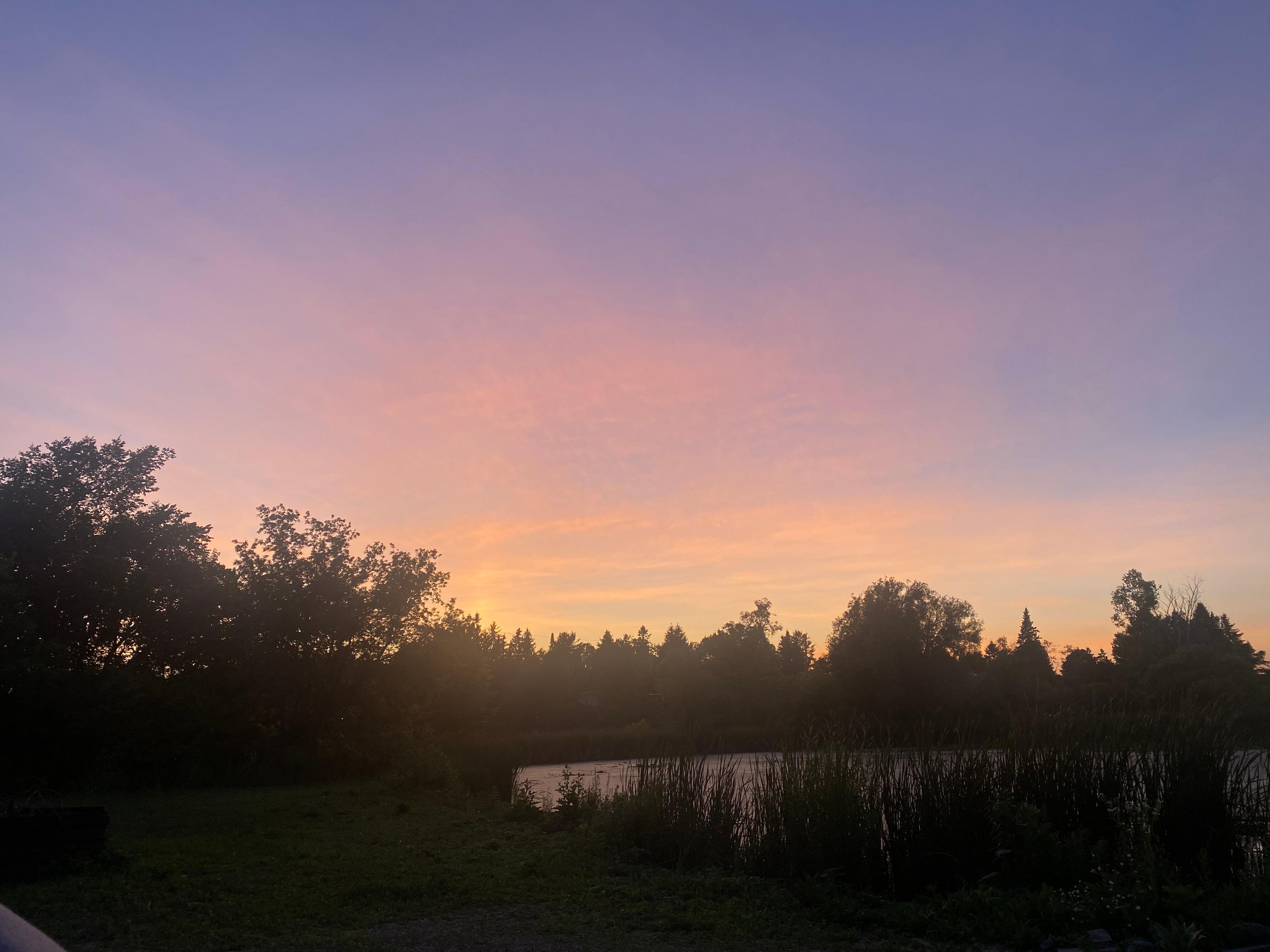 Sunset over the pond at back of property from the firepit