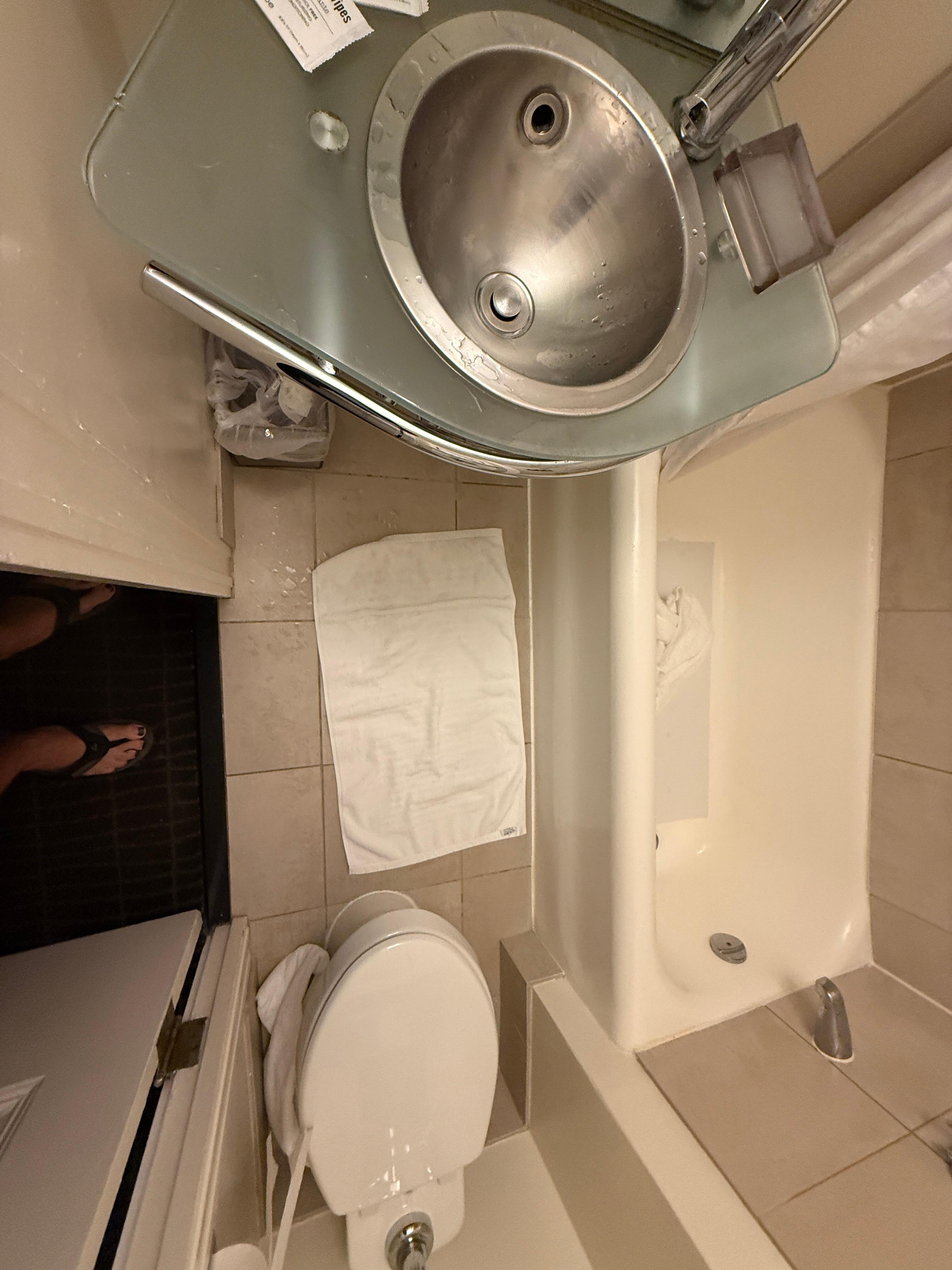 Me looking into bathroom to show how tiny it is. European sized.
