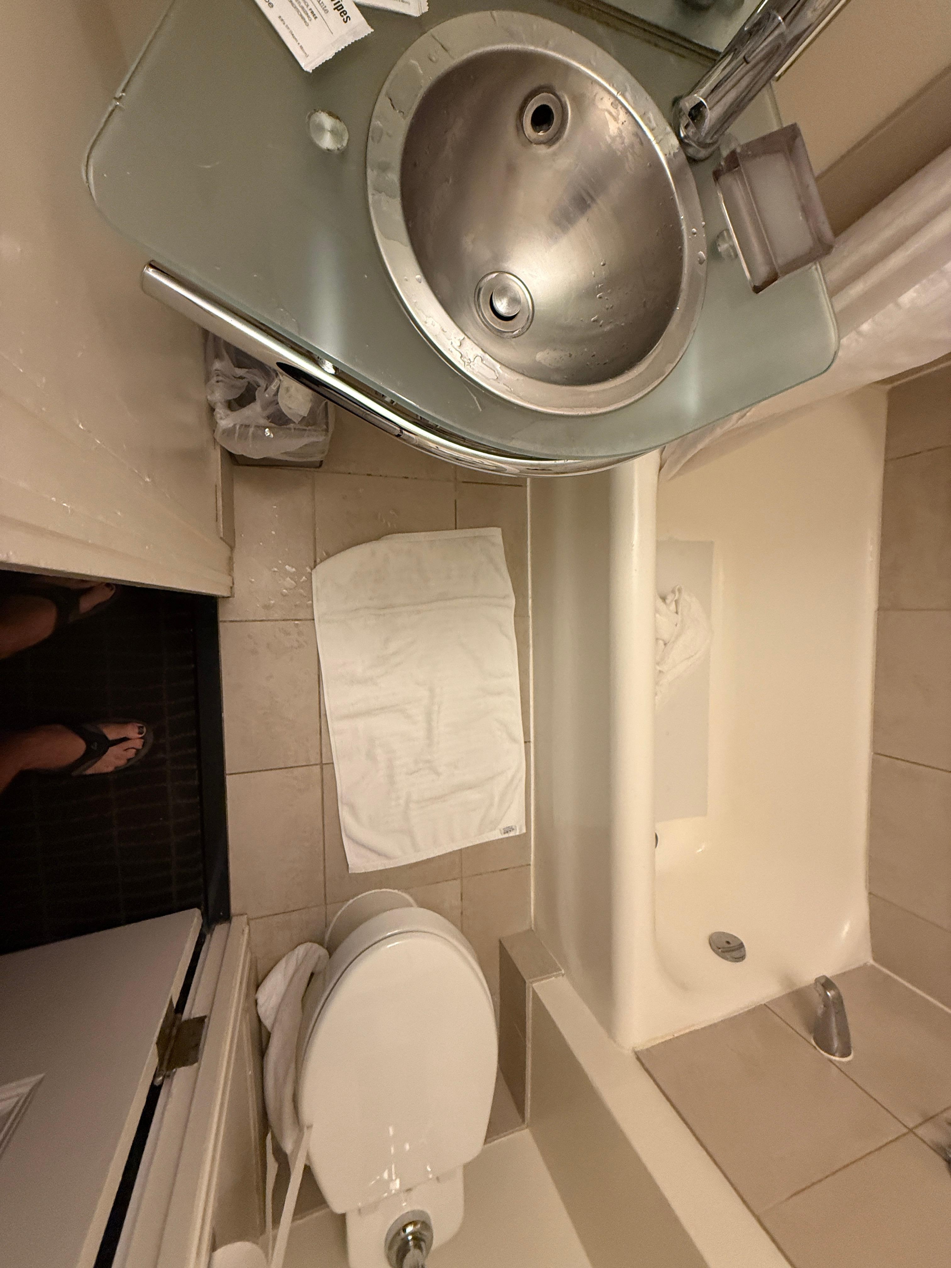 Me looking into bathroom to show how tiny it is. European sized.